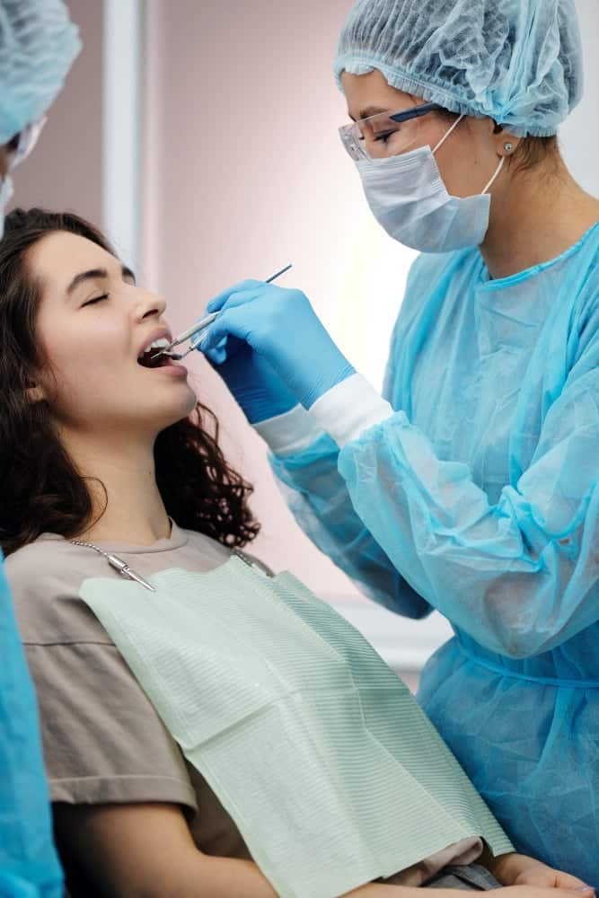 A dentist examining a patient’s gums