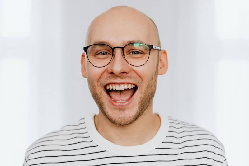 A man smiling after periodontal treatment