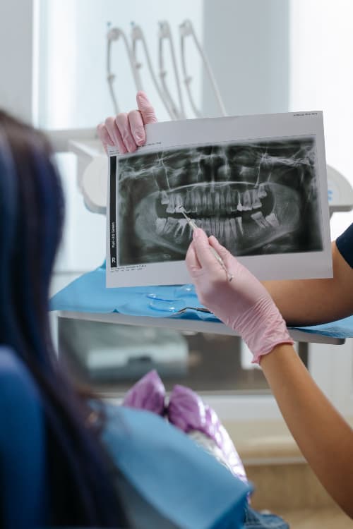 A dentist reviewing a digital X-ray