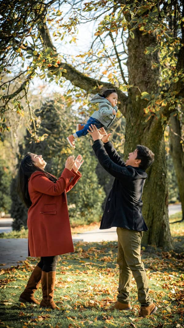 A young family playing outdoors in the fall